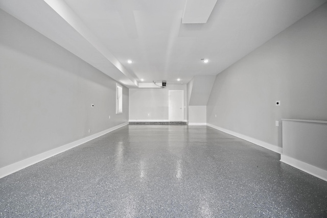 spare room featuring speckled floor, recessed lighting, and baseboards