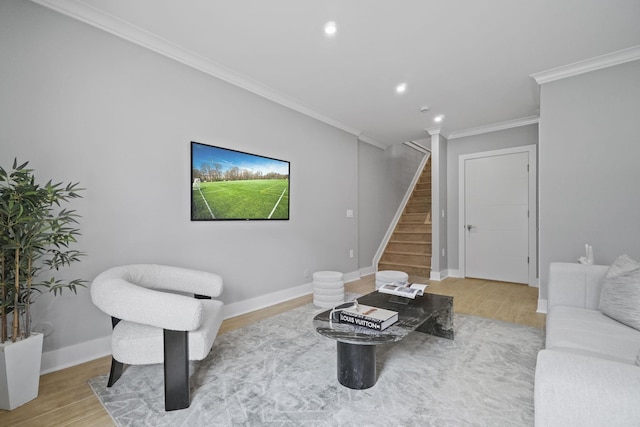 living area with crown molding, stairway, baseboards, and wood finished floors