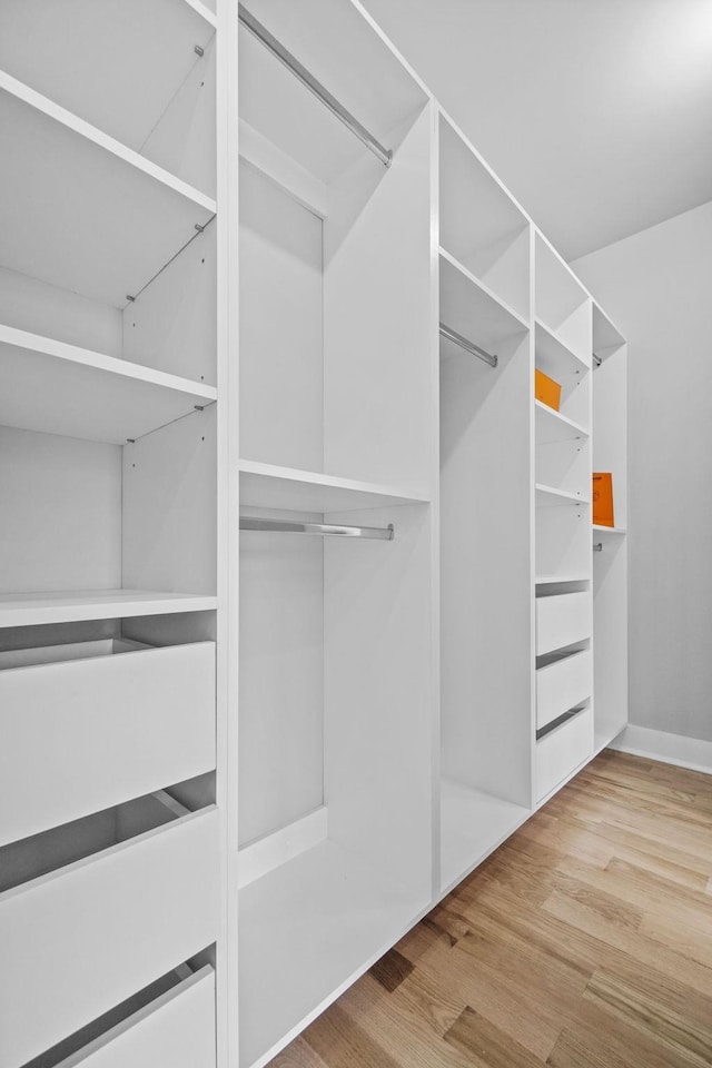 walk in closet featuring light wood finished floors