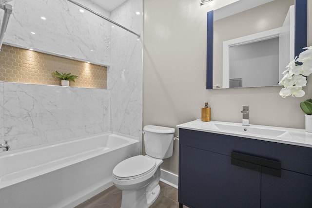 bathroom with baseboards, toilet, vanity, tile patterned floors, and shower / bathtub combination