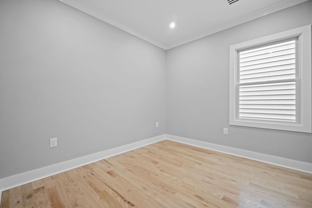 spare room with light wood-type flooring and baseboards