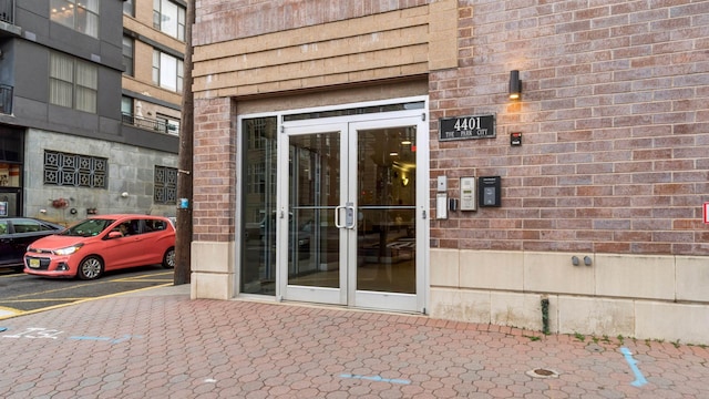4401 Park Ave Unit 2B, Union City, NJ 07087 - view of exterior entry featuring uncovered parking, french doors, and brick siding