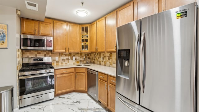 4401 Park Ave Unit 2B, Union City, NJ 07087 - kitchen with appliances with stainless steel finishes, light marble finish flooring, light countertops, glass insert cabinets, and tasteful backsplash