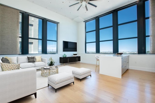 living room featuring light hardwood / wood-style floors and ceiling fan