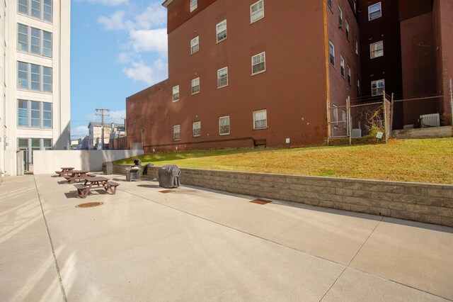 surrounding community featuring a patio area and a lawn