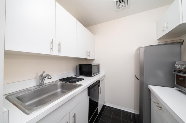 kitchen with visible vents, white cabinetry, black dishwasher, and a sink