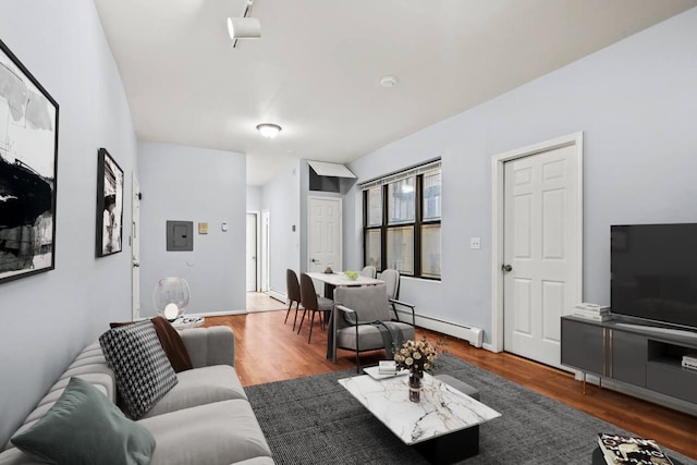 living room featuring baseboard heating and dark wood-type flooring