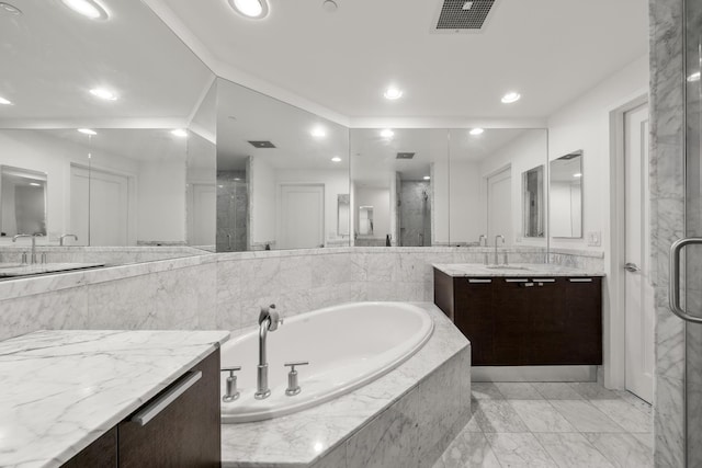 bathroom featuring shower with separate bathtub and vanity