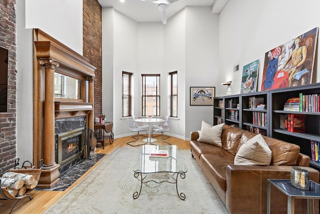 1110 Hudson St Unit 5B, Hoboken, NJ 07030 - living room featuring a fireplace, wood finished floors, baseboards, and a high ceiling