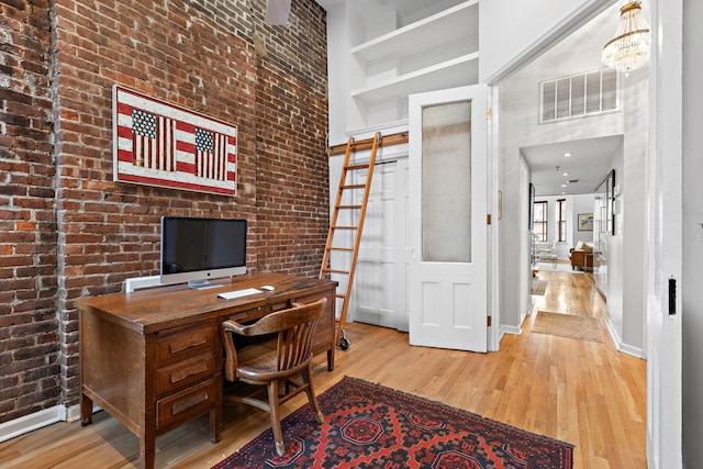 1110 Hudson St Unit 5B, Hoboken, NJ 07030 - office space featuring wood finished floors, baseboards, a towering ceiling, and brick wall