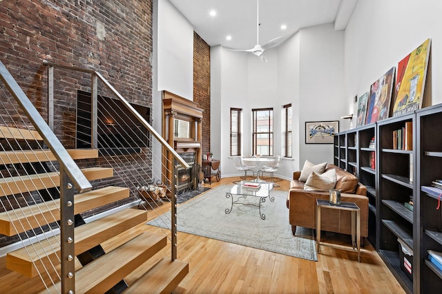 1110 Hudson St Unit 5B, Hoboken, NJ 07030 - living area featuring a high ceiling, wood finished floors, a fireplace with flush hearth, baseboards, and recessed lighting
