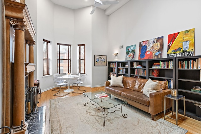 1110 Hudson St Unit 5B, Hoboken, NJ 07030 - living area with baseboards, a towering ceiling, wood finished floors, a high end fireplace, and ceiling fan