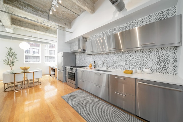 140 Bay St Unit 6G, Jersey City, NJ 07302 - kitchen featuring stainless steel appliances, modern cabinets, wall chimney exhaust hood, light wood-type flooring, and backsplash