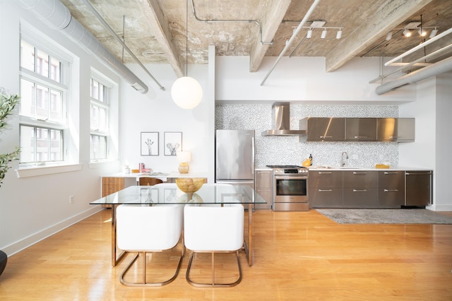 140 Bay St Unit 6G, Jersey City, NJ 07302 - kitchen featuring appliances with stainless steel finishes, wall chimney exhaust hood, light wood-type flooring, and dark brown cabinetry