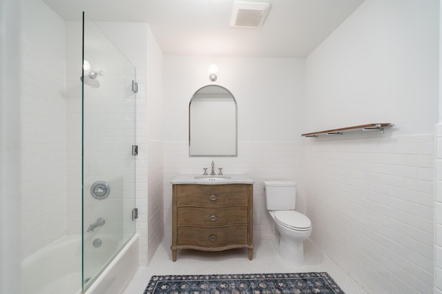 140 Bay St Unit 6G, Jersey City, NJ 07302 - bathroom featuring tile patterned floors, a wainscoted wall, shower / bath combination with glass door, vanity, and tile walls