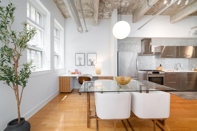 140 Bay St Unit 6G, Jersey City, NJ 07302 - kitchen featuring wall chimney exhaust hood, appliances with stainless steel finishes, light wood-style floors, and modern cabinets