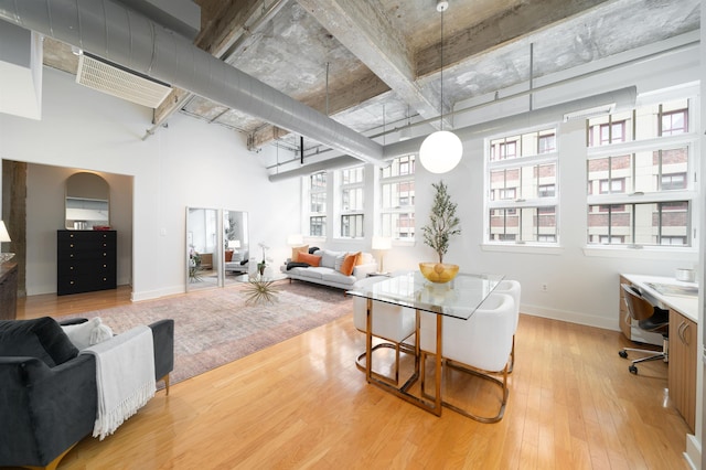 140 Bay St Unit 6G, Jersey City, NJ 07302 - living room featuring a high ceiling, wood finished floors, and a desk