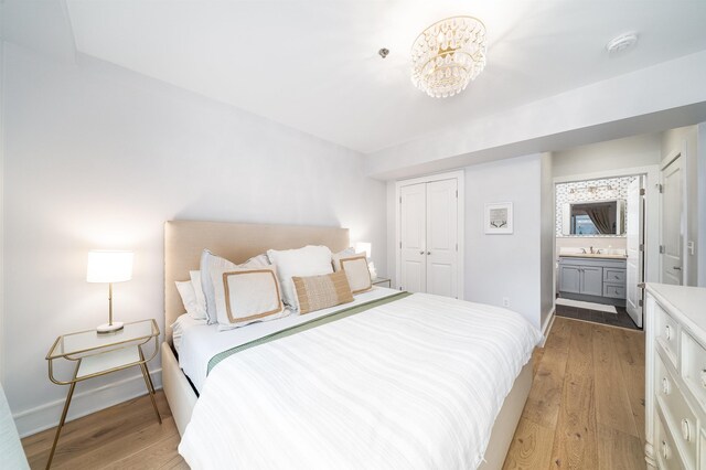 833 Willow Ave Unit 2, Hoboken, NJ 07030 - bedroom with light wood-style flooring, a closet, and ensuite bath