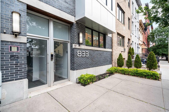 833 Willow Ave Unit 2, Hoboken, NJ 07030 - view of exterior entry with brick siding and a patio