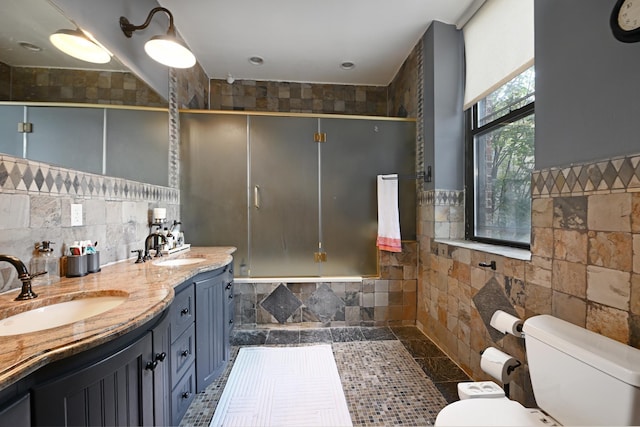 1620 Manhattan Ave Unit C3, Union City, NJ 07087 - bathroom featuring tile walls, toilet, double vanity, and tiled shower / bath combo