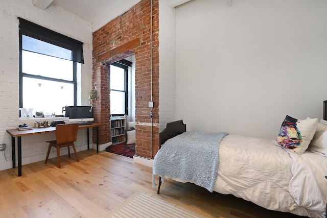 1620 Manhattan Ave Unit C3, Union City, NJ 07087 - bedroom featuring wood finished floors, brick wall, and an office area