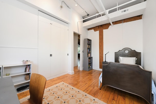 1620 Manhattan Ave Unit C3, Union City, NJ 07087 - bedroom featuring hardwood / wood-style floors, a high ceiling, rail lighting, baseboards, and a closet