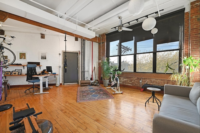 1620 Manhattan Ave Unit C3, Union City, NJ 07087 - living room featuring brick wall, a desk, and hardwood / wood-style flooring