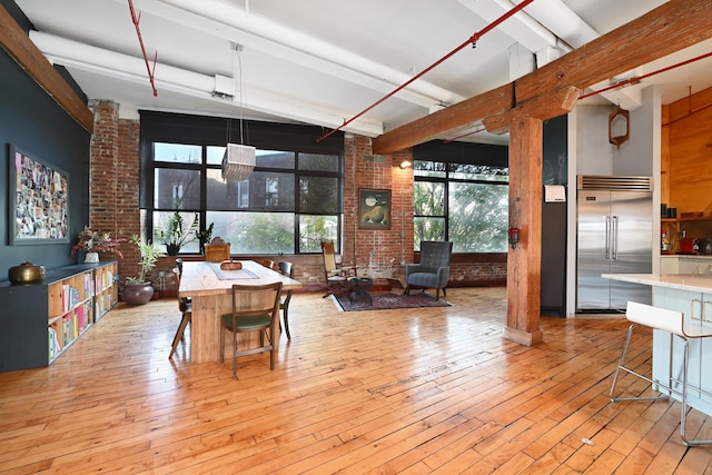 1620 Manhattan Ave Unit C3, Union City, NJ 07087 - dining area with brick wall, beamed ceiling, healthy amount of natural light, and wood-type flooring