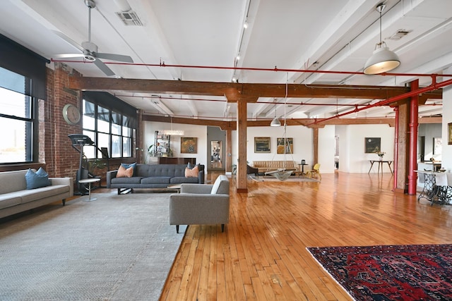 1620 Manhattan Ave Unit C3, Union City, NJ 07087 - living area featuring wood-type flooring, a ceiling fan, beam ceiling, and brick wall
