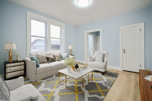 living area with wood finished floors and baseboards