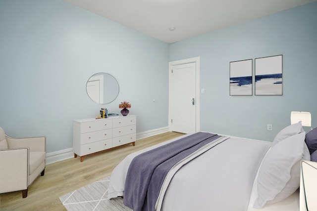 bedroom featuring light wood-style flooring and baseboards