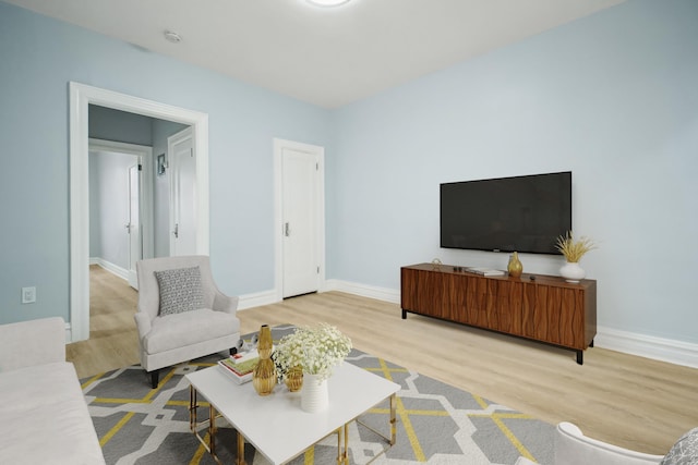 living area with wood finished floors and baseboards