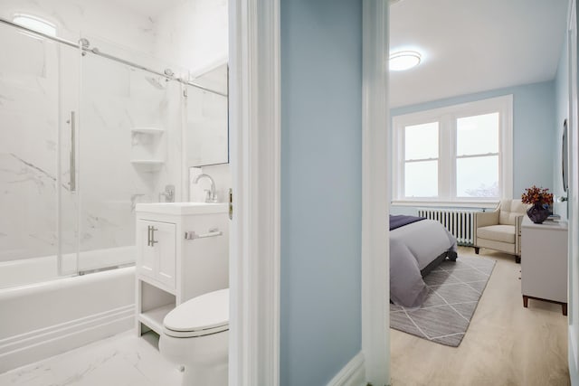 full bathroom with radiator heating unit, toilet, vanity, ensuite bath, and combined bath / shower with glass door