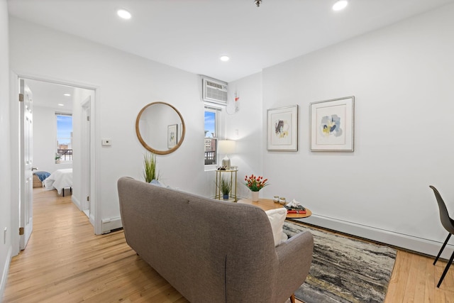 110 Washington St Unit 8, Hoboken, NJ 07030 - living room featuring baseboard heating, light wood-style floors, recessed lighting, and a wall mounted AC