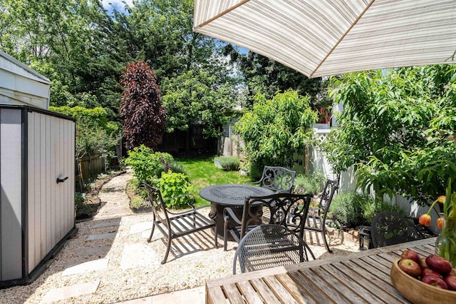 235 Sherman Ave, Jersey City, NJ 07307 - fenced backyard featuring outdoor dining area, a patio area, a shed, and view of wooded area