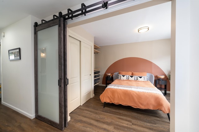 235 Sherman Ave, Jersey City, NJ 07307 - bedroom with wood finished floors, baseboards, and a barn door