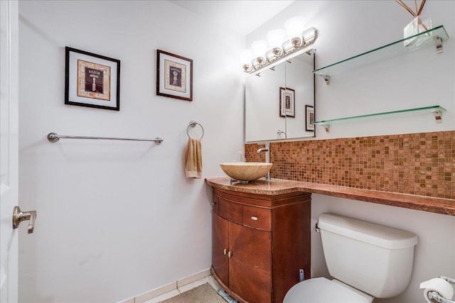 bathroom featuring tile patterned floors, vanity, toilet, and decorative backsplash