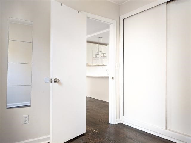 149 37th St, Union City, NJ 07087 - hallway featuring dark wood-style flooring and baseboards