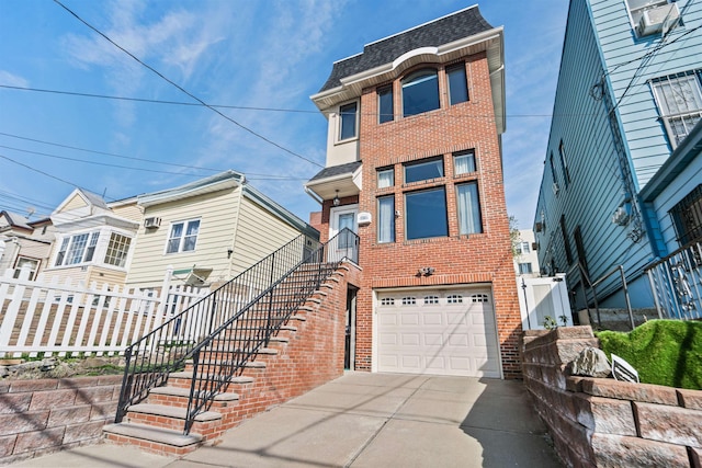 view of front of house featuring roof with shingles, a garage, brick siding, fence, and concrete driveway