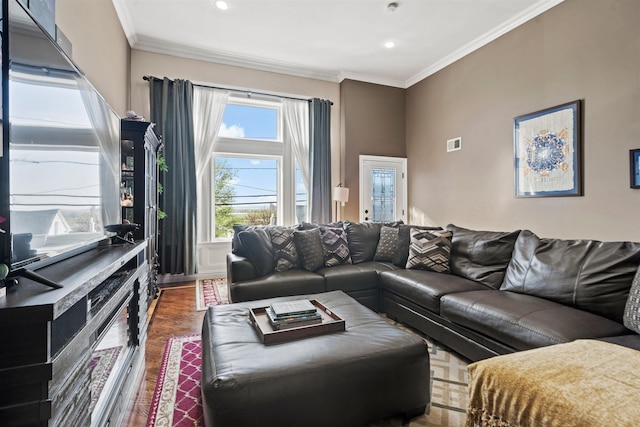 living area featuring ornamental molding, recessed lighting, wood finished floors, and visible vents