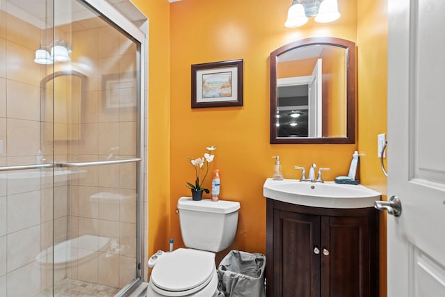 bathroom featuring vanity, toilet, and a stall shower