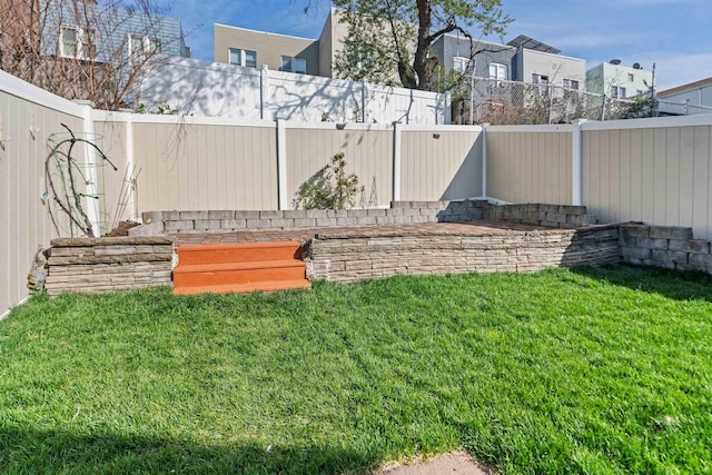 view of yard with a fenced backyard