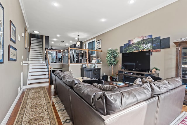 living area featuring crown molding, wood finished floors, baseboards, stairway, and recessed lighting