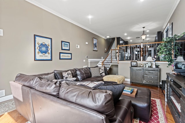 living room featuring crown molding, visible vents, wood finished floors, stairway, and recessed lighting