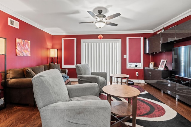 living area featuring visible vents, crown molding, ceiling fan, and wood finished floors
