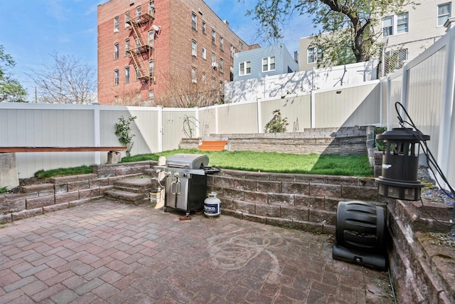 view of patio with a fenced backyard and area for grilling