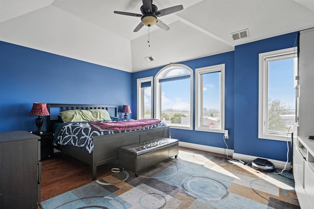 bedroom with vaulted ceiling, multiple windows, and visible vents