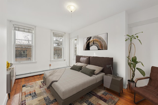 bedroom featuring a baseboard radiator and light hardwood / wood-style floors