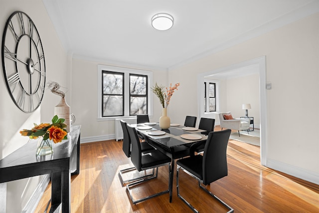 dining room with light wood finished floors and baseboards