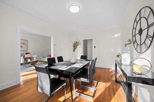 dining space featuring light wood-type flooring and baseboards